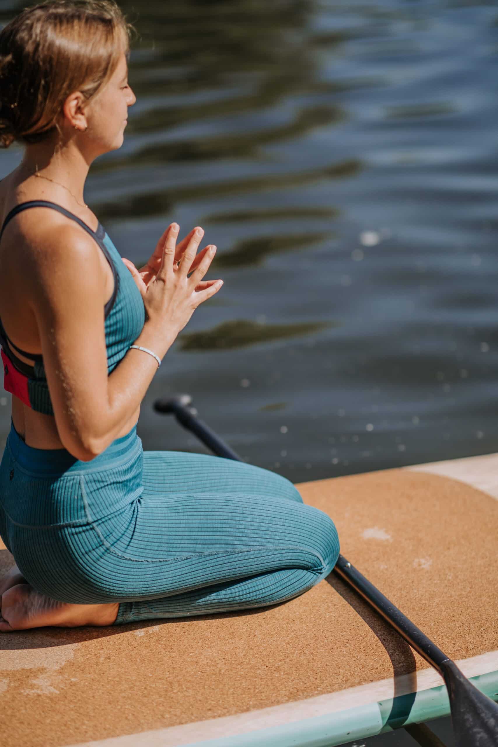Woman Kneeling On PIERRE Cork Paddleboard