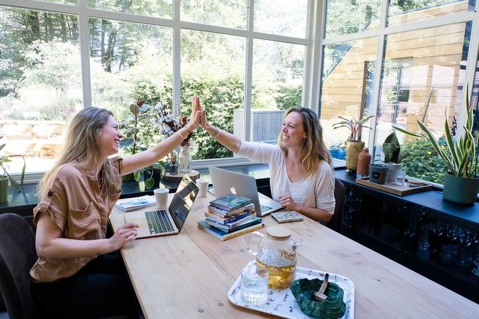 Two Women High Fiving At Work