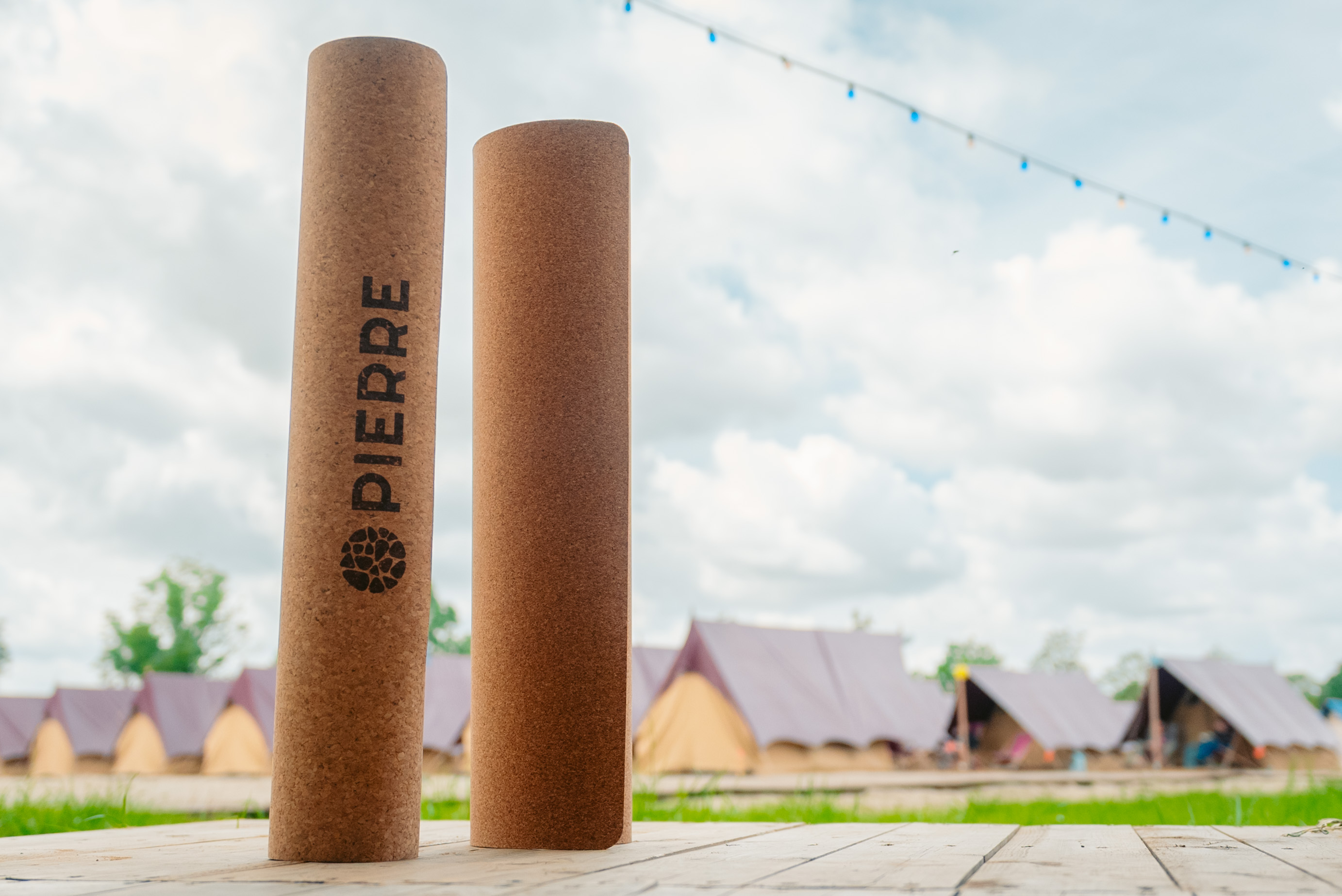 Rolled PIERRE cork mats stacked in a festival field