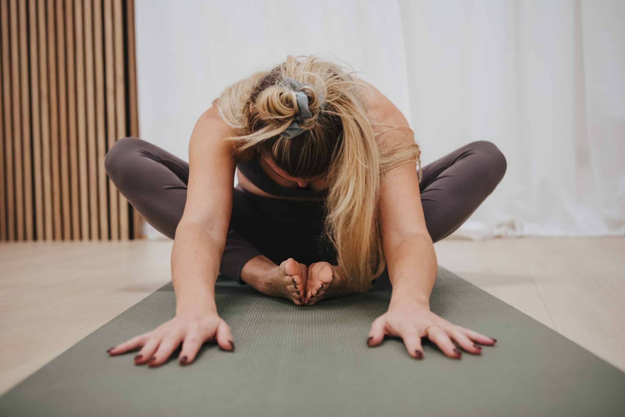 Woman Practicing Butterfly Fold On Yoga Mat