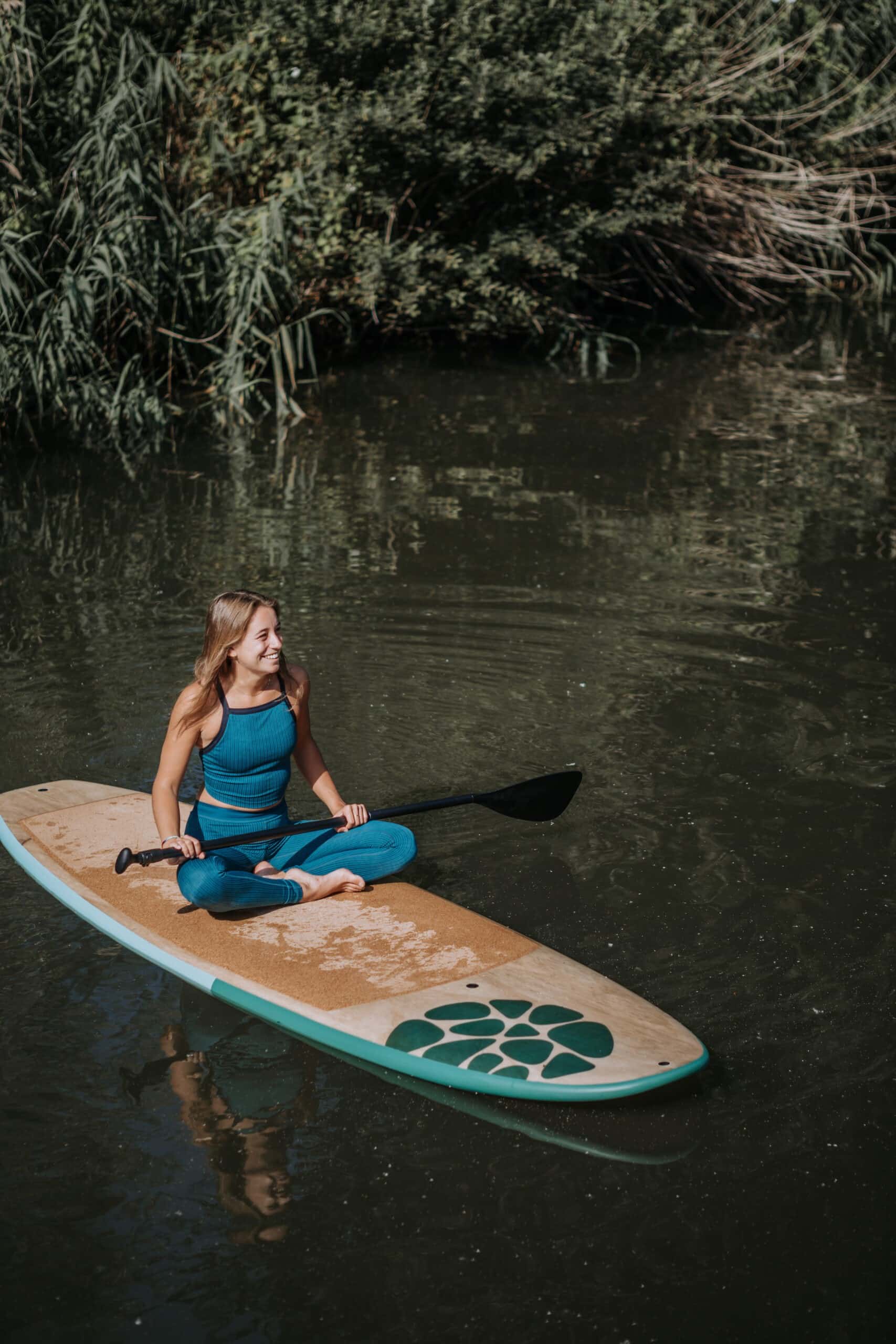 Woman Sitting On PIERRE Paddle Board