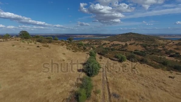 Dry Grass Hills With Distant Lake