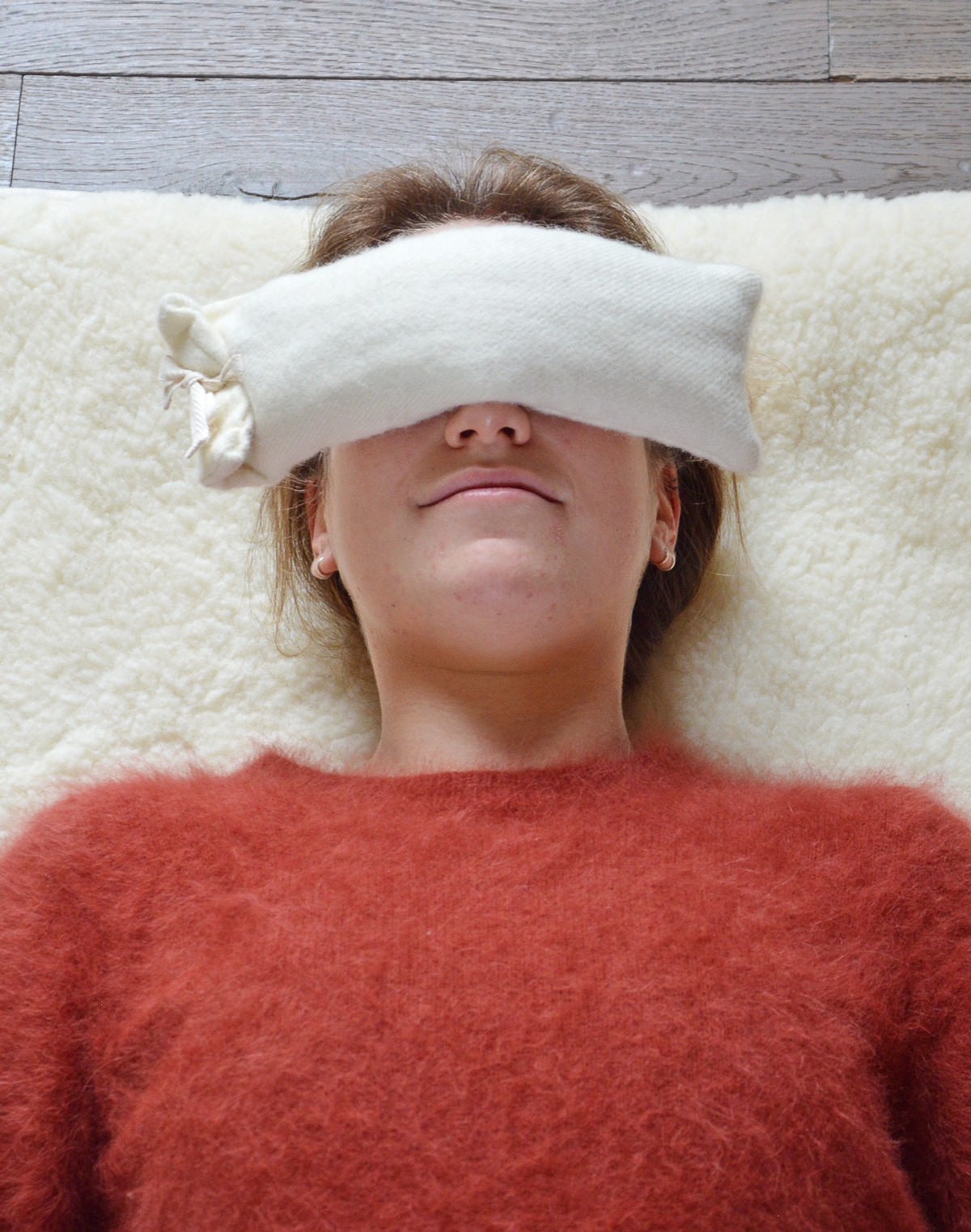 Woman Using PIERRE Wool Eye Pillow