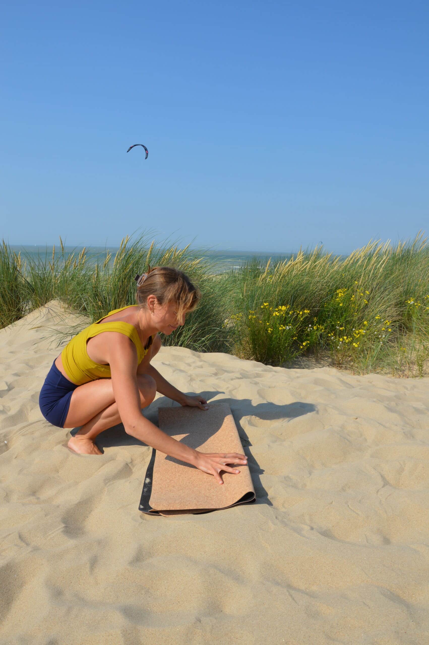 Woman Unrolling PIERRE Cork Yoga Mat