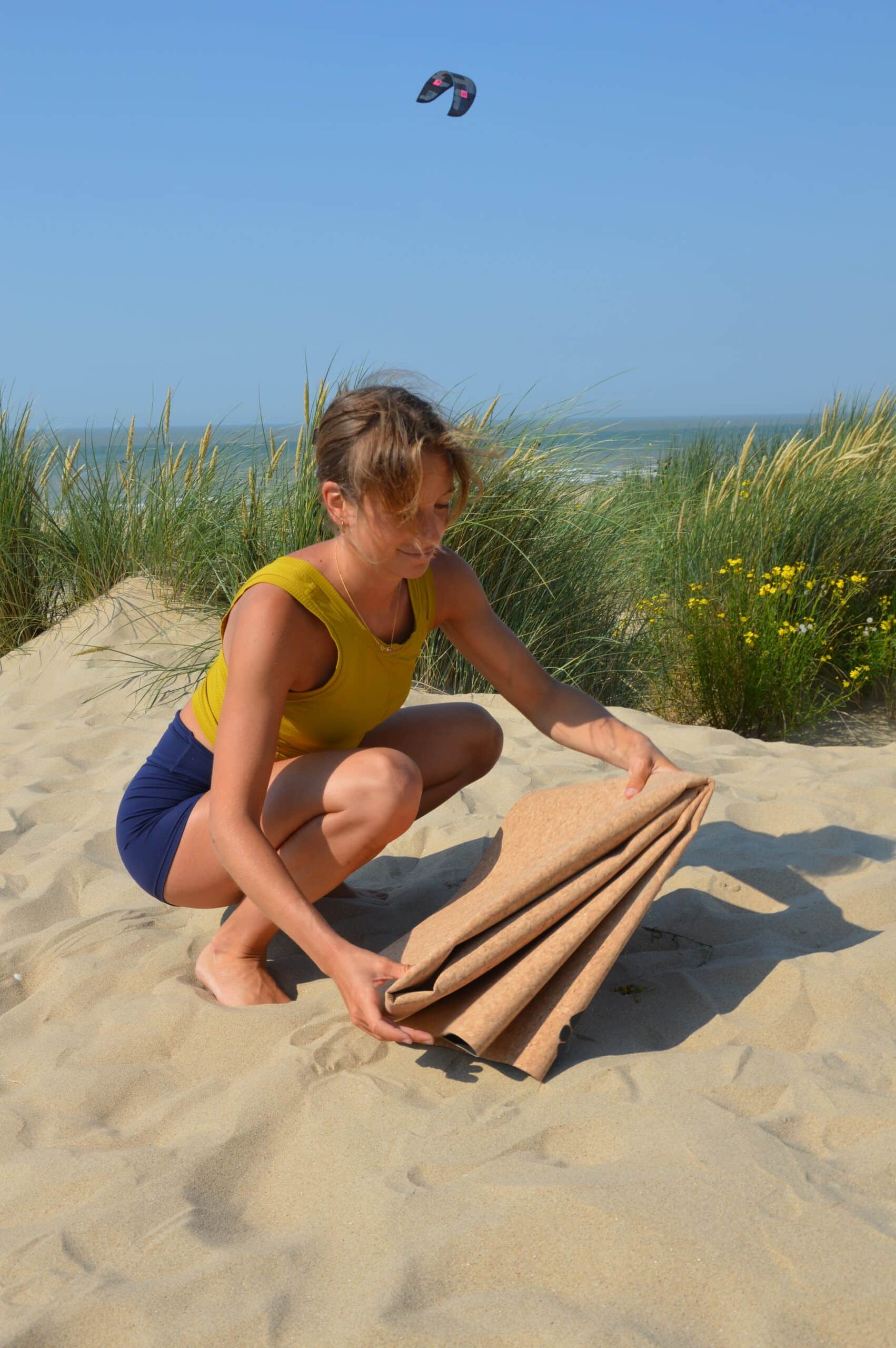 Woman Folding PIERRE Cork Yoga Mat