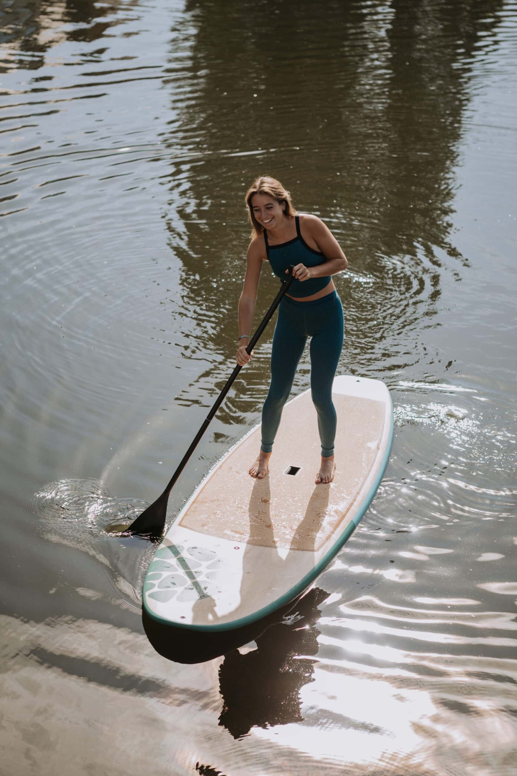 Woman Paddle Boarding On Cork Surface