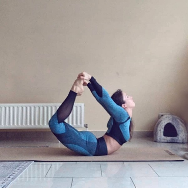 Woman Holding Bow Pose On PIERRE Mat