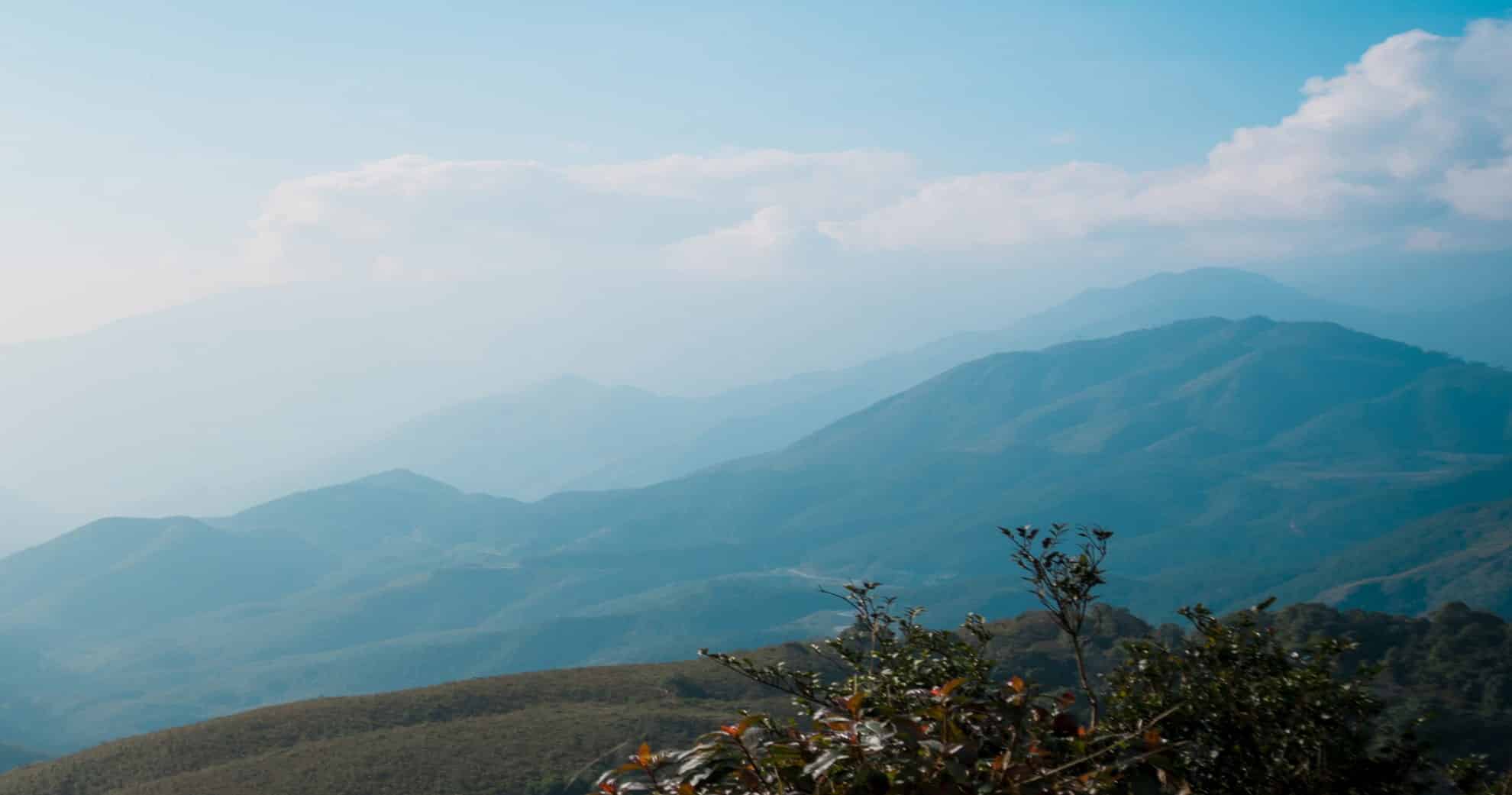 Panoramic Misty Mountain Peaks And Blue Sky