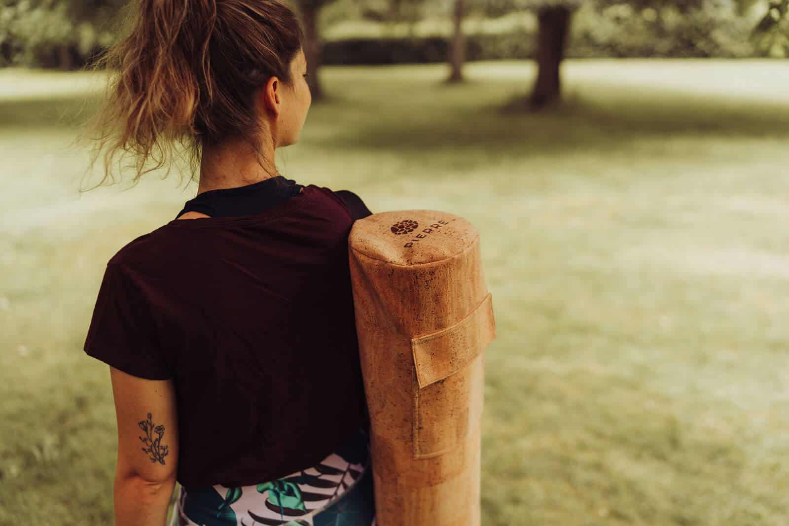 Woman Carrying PIERRE Cork Yoga Mat