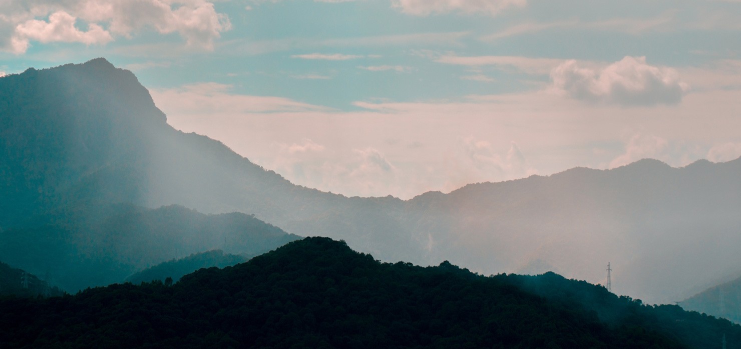 Misty Mountain Peaks At Sunset