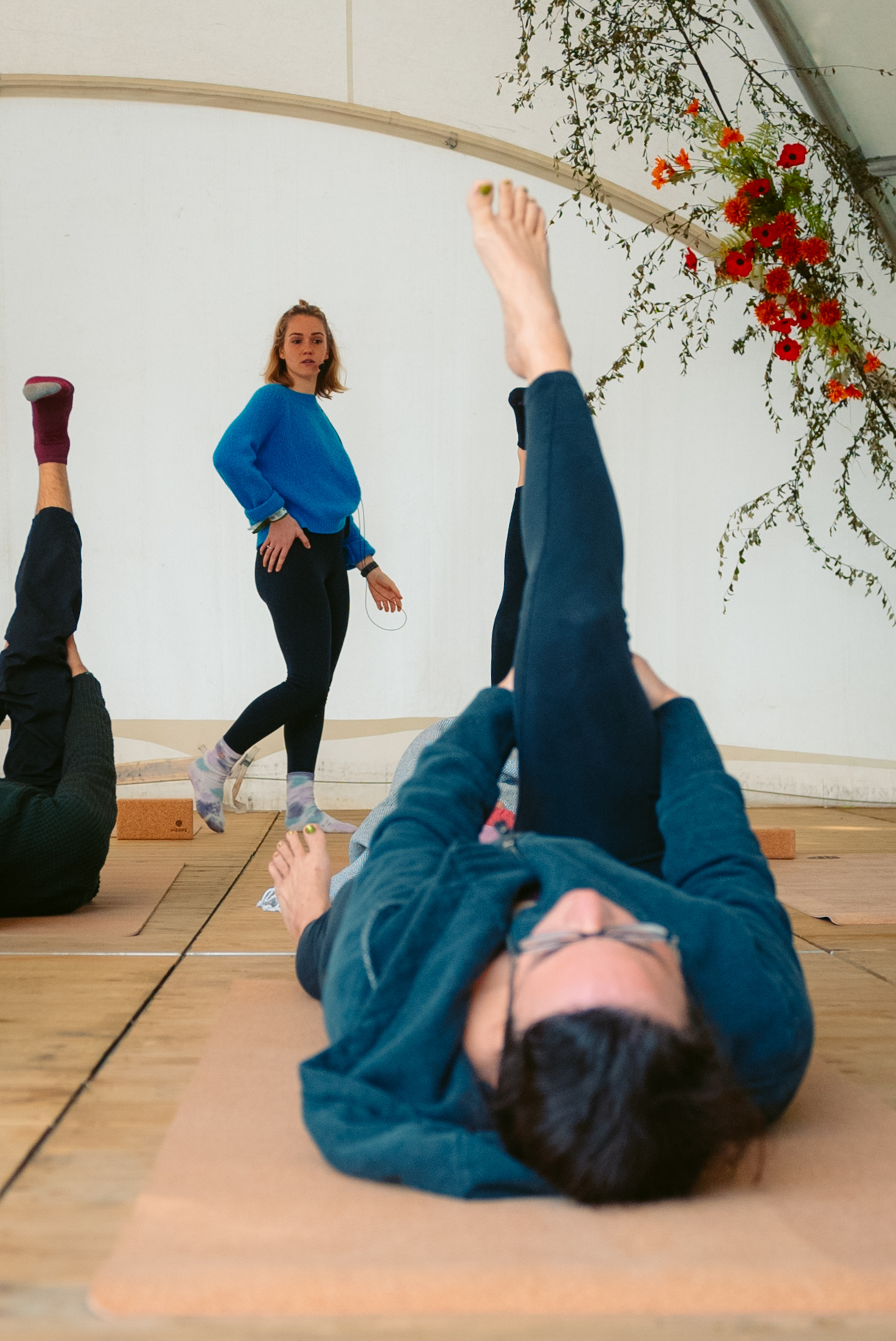 Rock Werchter Teacher Guiding Legs Up Pose
