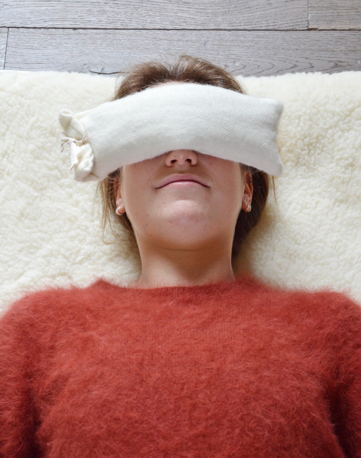 Woman Practicing Savasana With Eye Pillow